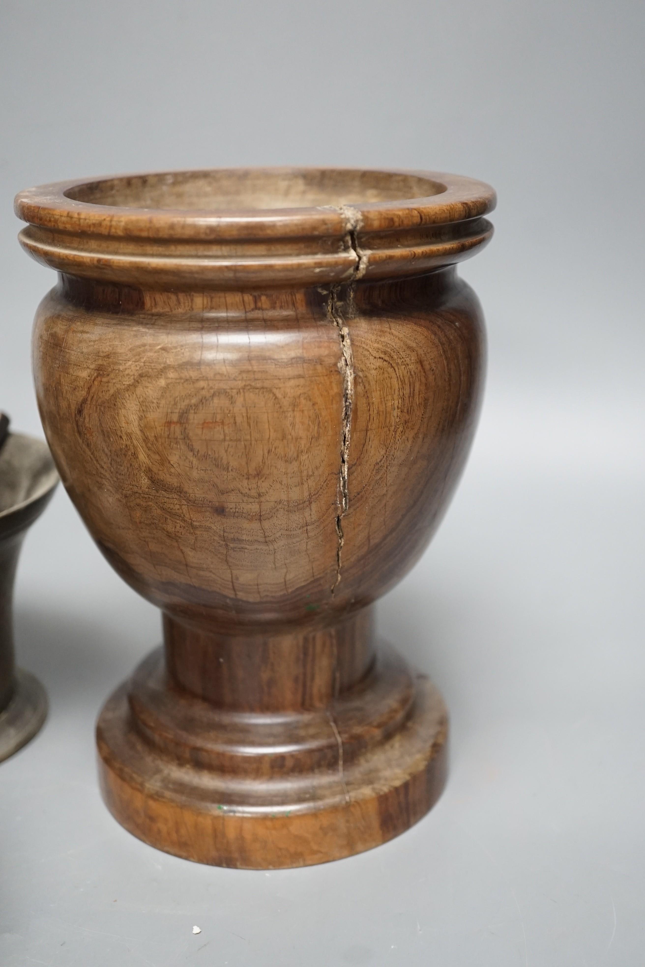 Three bell metal mortars, two pestles, a turned lignum vitae mortar and three postal weights, urn height 20cm